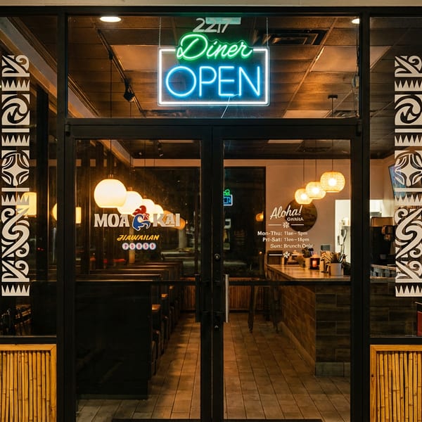 Exterior of Moa Kai Hawaiian Diner at night, with a neon "Diner OPEN" sign glowing.